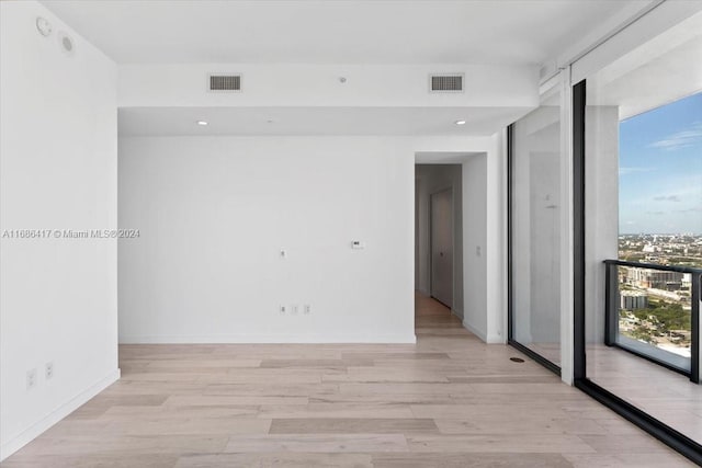 empty room with light hardwood / wood-style flooring