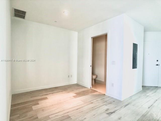 empty room featuring light hardwood / wood-style flooring and electric panel