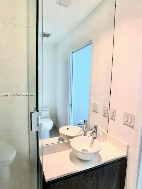 bathroom with toilet and vanity