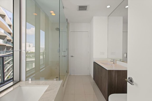 bathroom featuring a shower with door, vanity, toilet, and tile patterned floors