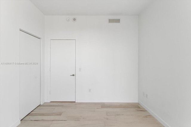 spare room featuring light hardwood / wood-style floors