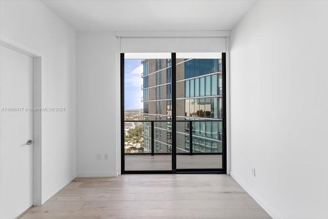 unfurnished room with light wood-type flooring