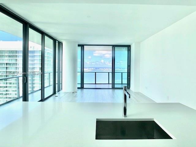 empty room featuring sink and expansive windows