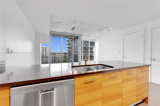 kitchen with sink, decorative light fixtures, stainless steel dishwasher, floor to ceiling windows, and a chandelier