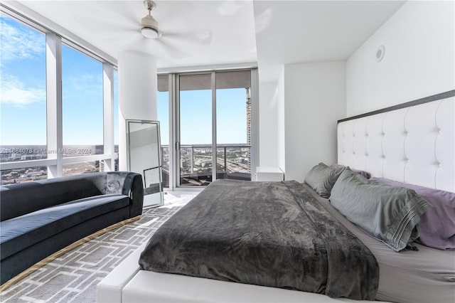 bedroom featuring ceiling fan and a wall of windows