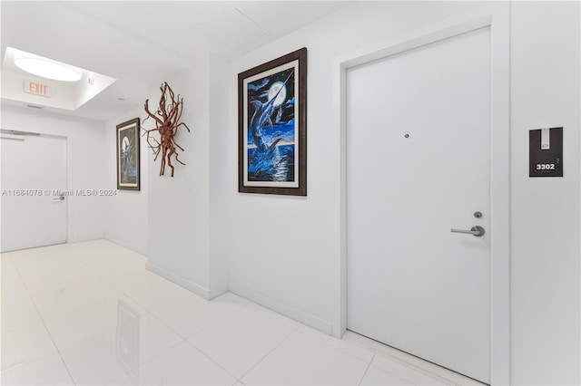 corridor with light tile patterned floors