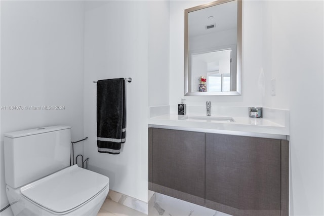 bathroom featuring vanity and toilet