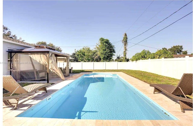 view of swimming pool with a gazebo and a patio