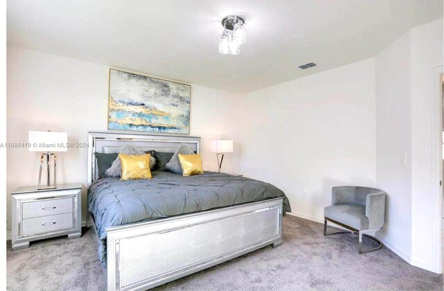 2613 SW Harem Cir, Port St Lucie, FL 34953 - bedroom with carpet floors and baseboards