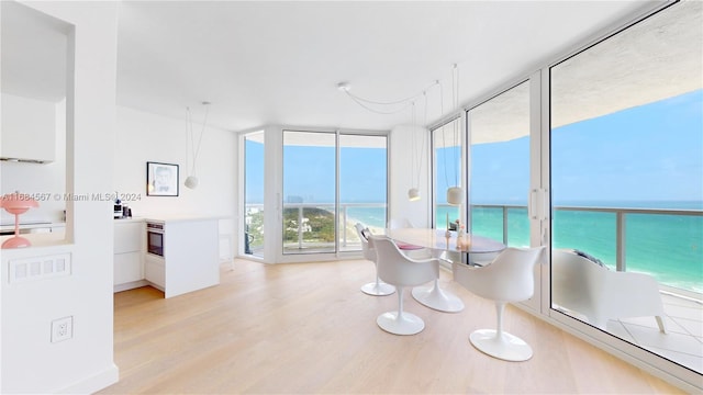 sunroom / solarium featuring a water view