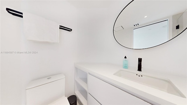 bathroom with vanity and toilet