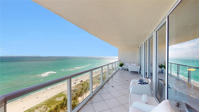 balcony with a water view and a beach view