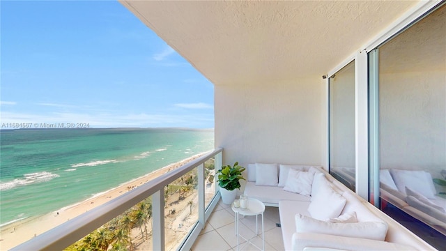 balcony featuring a water view and a view of the beach