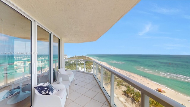 balcony with a water view and a beach view