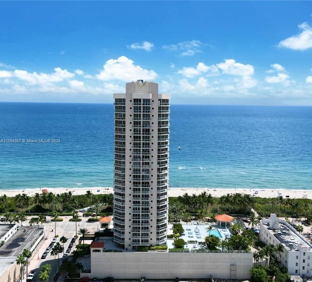 birds eye view of property with a beach view and a water view