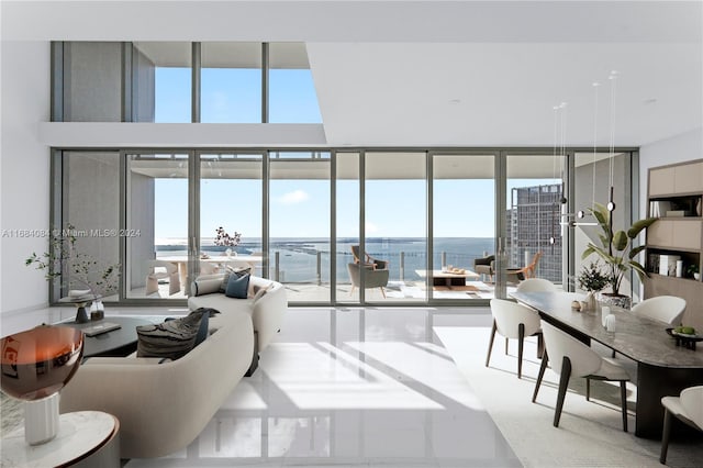 living room featuring a wall of windows and a water view