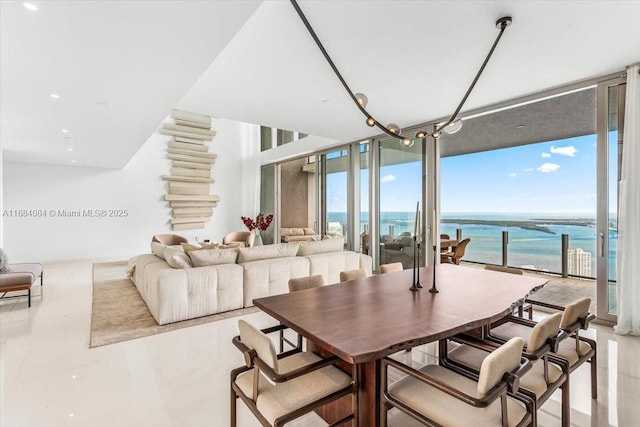 dining room with a water view and a wall of windows