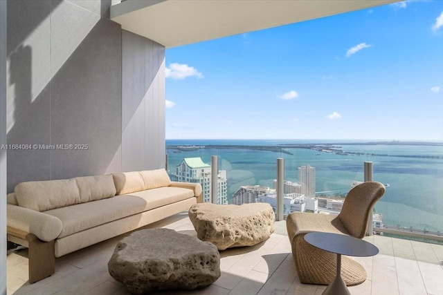 balcony with a water view, a view of city, and an outdoor hangout area