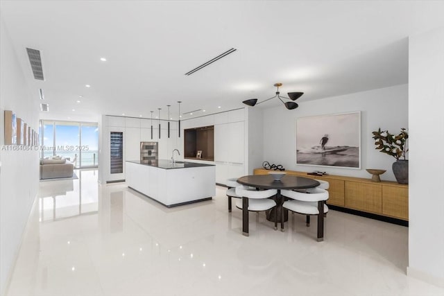 dining room featuring a wall of windows, visible vents, and recessed lighting