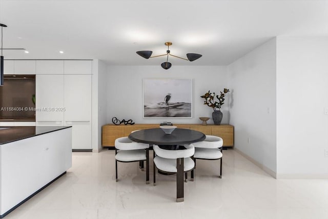 dining area featuring recessed lighting and marble finish floor