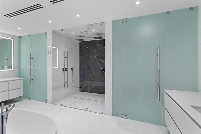 bathroom featuring recessed lighting, a marble finish shower, visible vents, and vanity