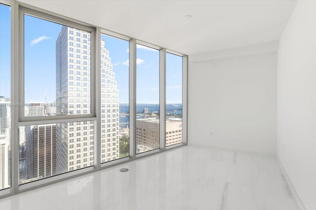 unfurnished room featuring expansive windows and a city view