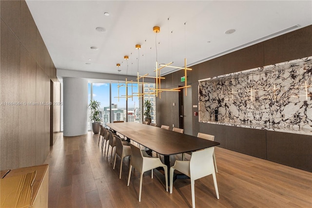 dining area featuring wood finished floors and a city view