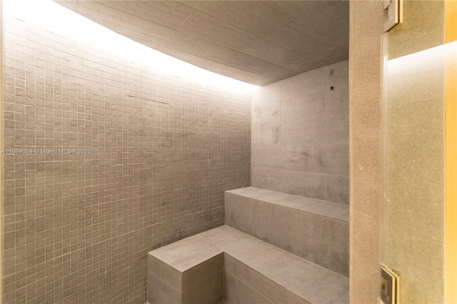 full bath featuring a tile shower