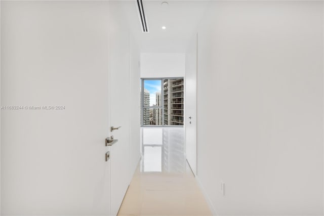 hall featuring light tile patterned floors