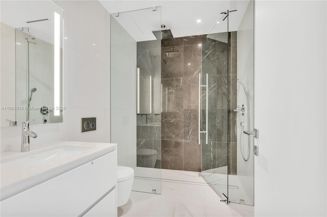 bathroom with toilet, an enclosed shower, and vanity