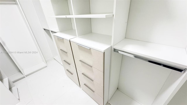 spacious closet with light tile patterned floors