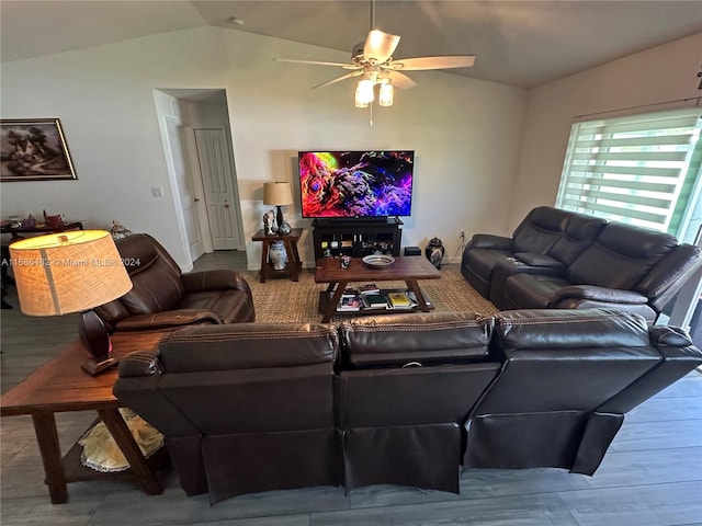 living room featuring ceiling fan, lofted ceiling, and wood-type flooring