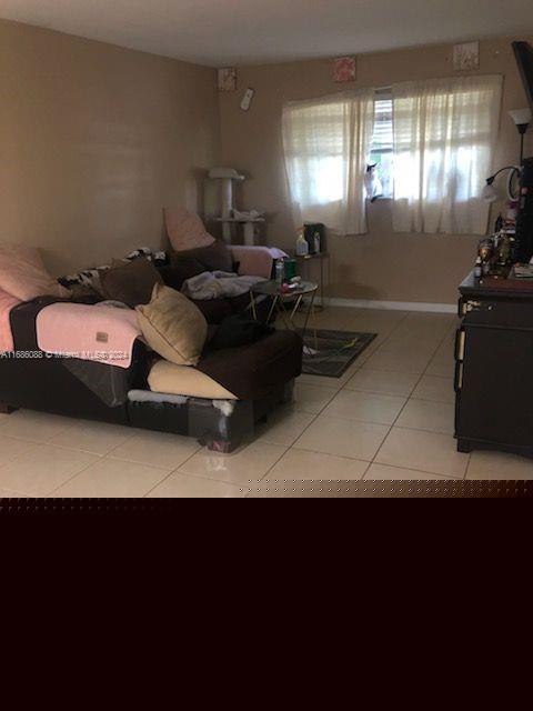 bedroom featuring light tile patterned floors