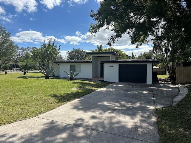 view of front of property with a front yard and a garage