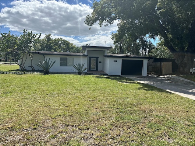 view of front of house with a front lawn and a garage