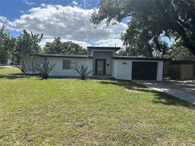 2128 Sycamore Dr, Winter Park, FL 32789 - view of front of house with stucco siding, an attached garage, a front yard, and concrete driveway