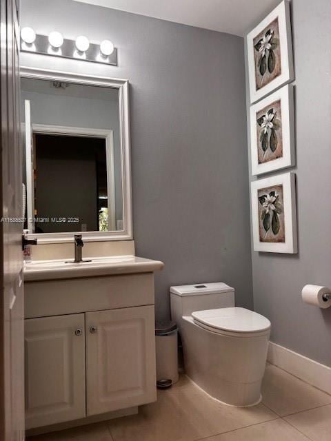 bathroom with tile patterned floors, vanity, and toilet