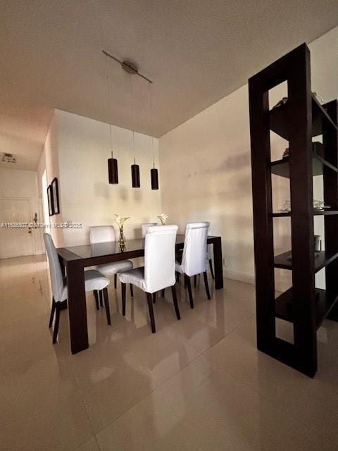 tiled dining area with track lighting