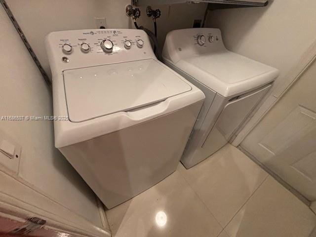 laundry area featuring tile patterned flooring and separate washer and dryer