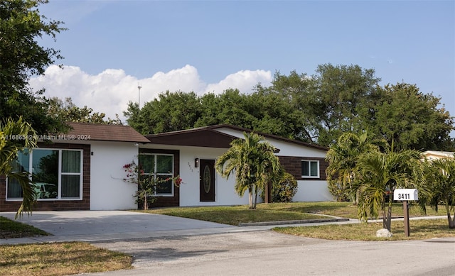 ranch-style home with a front lawn