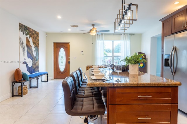 dining area with light tile patterned floors and ceiling fan