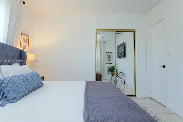 bedroom featuring a closet and light tile patterned floors