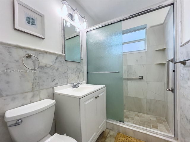 bathroom featuring vanity, toilet, walk in shower, and tile walls