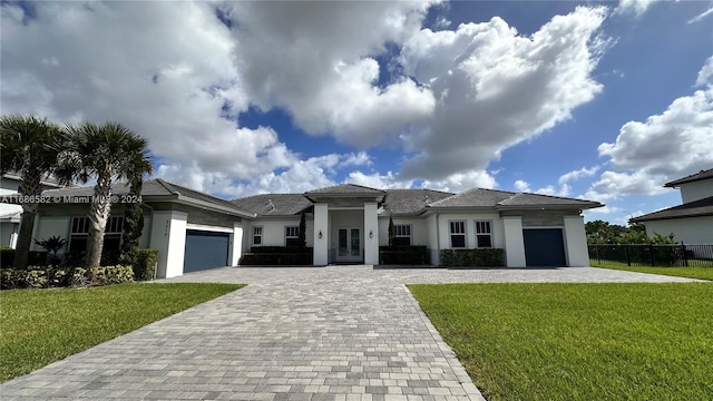 view of front of property featuring a front yard and a garage