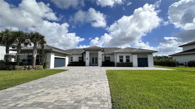 view of front facade with a garage and a front lawn