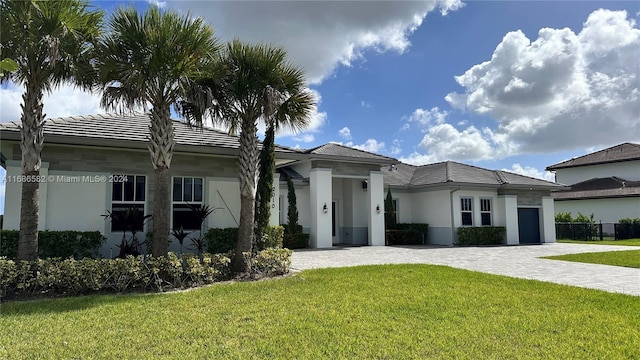 view of front of home with a front lawn and a garage