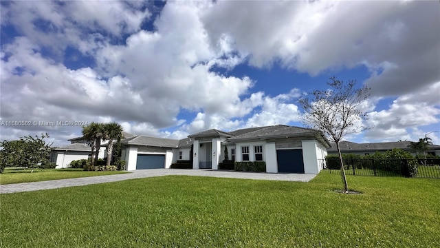 view of front of house featuring a front lawn and a garage