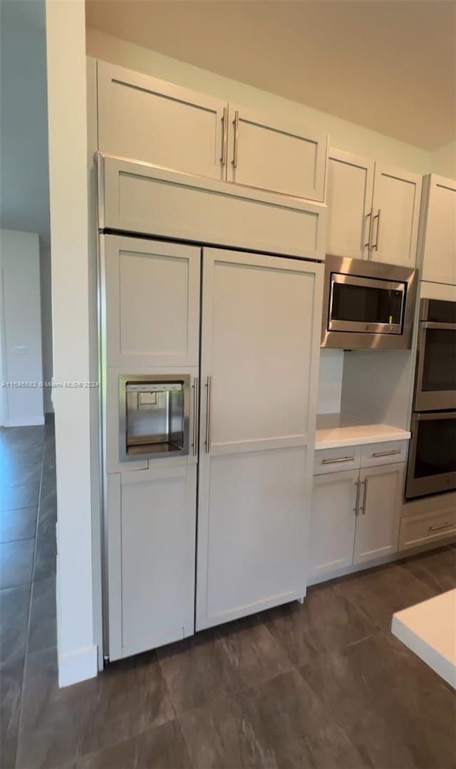 kitchen with appliances with stainless steel finishes and white cabinets