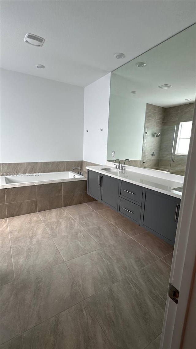 bathroom featuring vanity, shower with separate bathtub, and tile patterned flooring