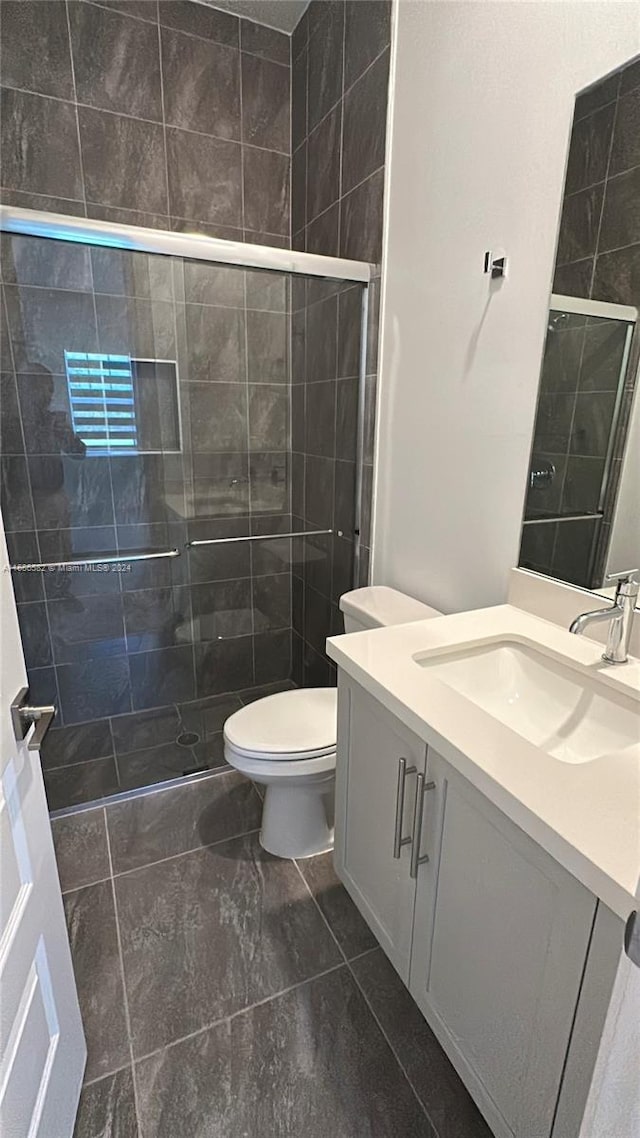 bathroom with vanity, toilet, and walk in shower